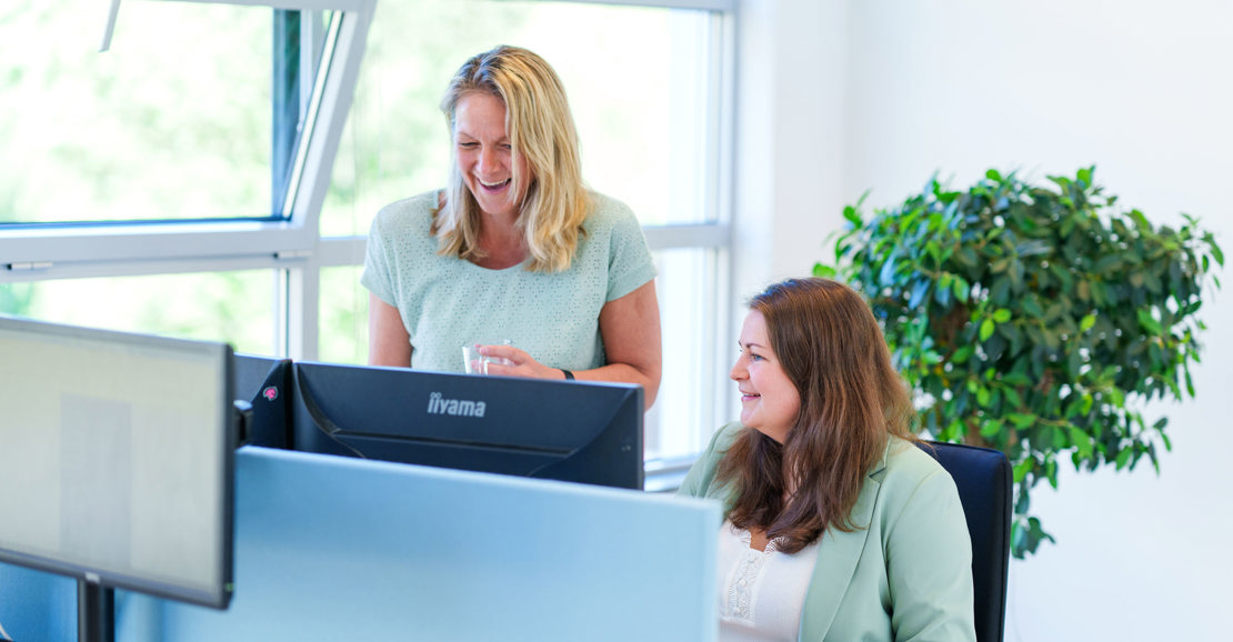 Collega's Manon en Carolien achter computer